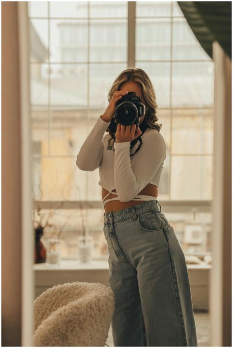 Elegant woman taking a photo with a DSLR in a mode