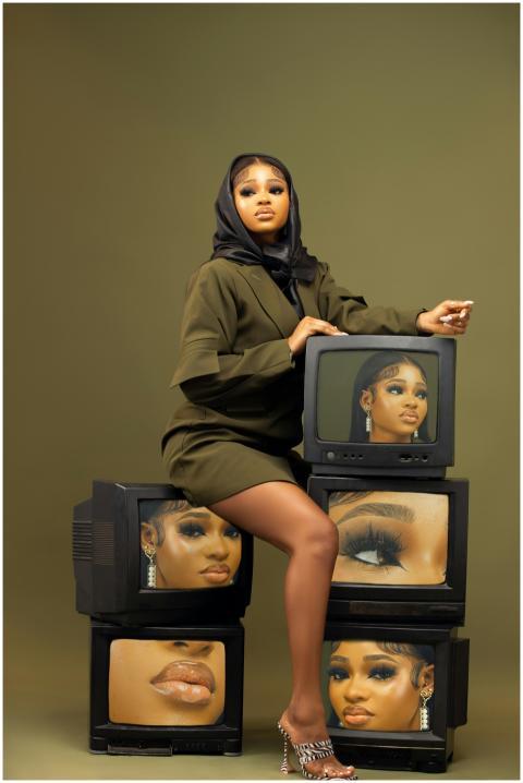 Artistic studio shot of a woman in olive outfit wi