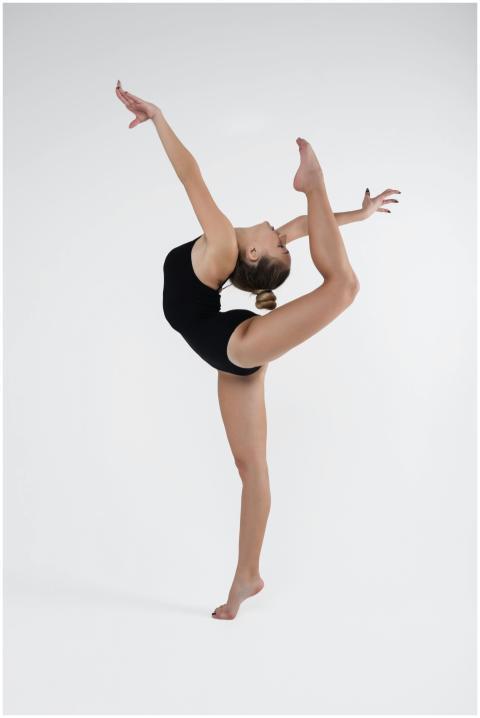 A skilled ballet dancer demonstrating flexibility