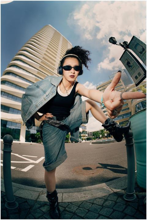 Fashionable young adult showing a peace sign in a