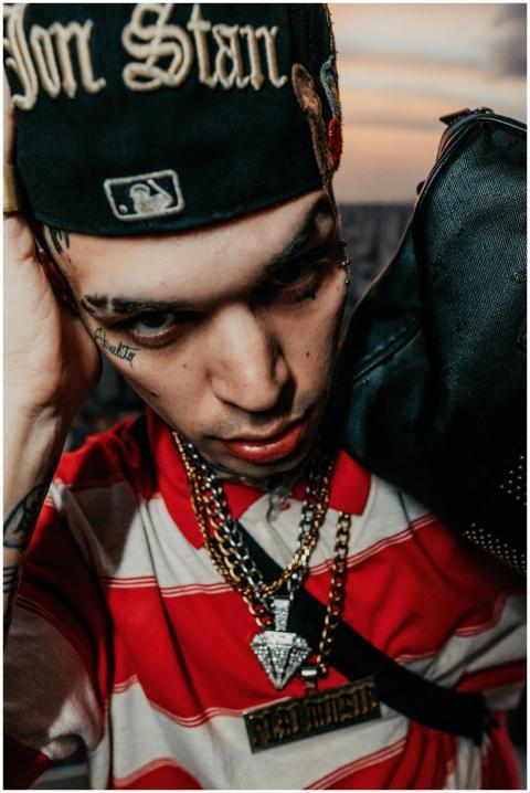 Close-up of a fashionable young man with tattoos a