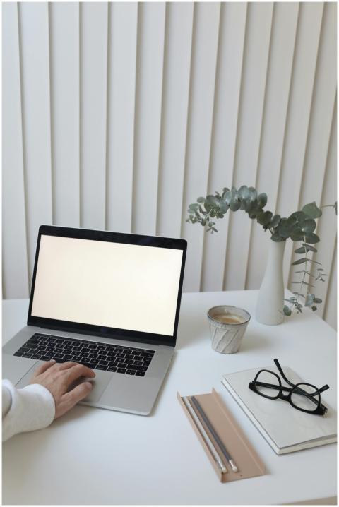 A clean, minimalist workspace featuring a laptop w