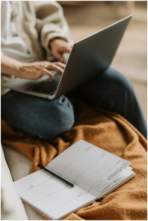 Cozy work setup with a laptop and planner for prod