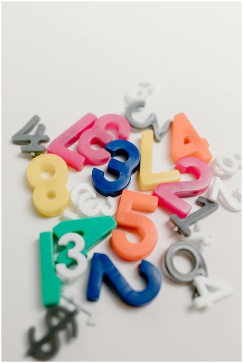 Vibrant plastic numbers scattered on a white backg