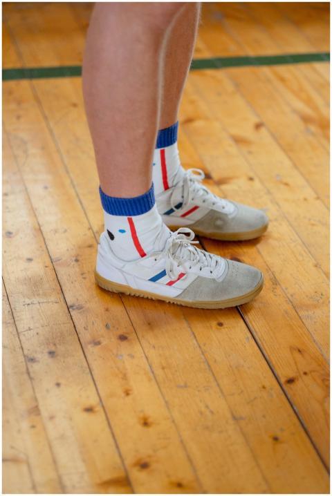 A close-up view of legs wearing colorful socks and