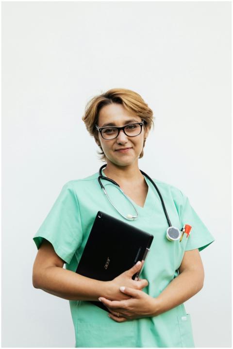 Confident female nurse with eyeglasses holding a t