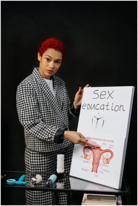 A woman presents a sex education topic using a dia