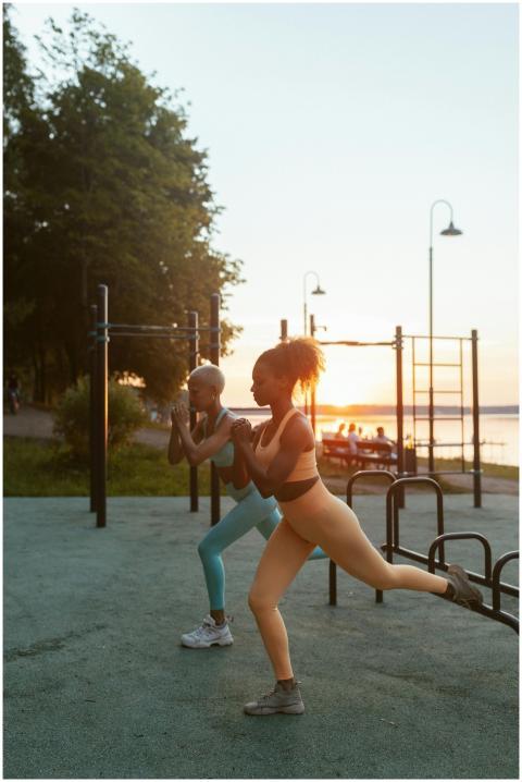 Two women exercising outdoors at sunset, demonstra