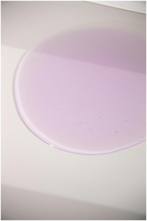 Abstract image of purple liquid forming a smooth c