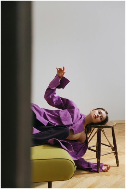 Stylish woman in a purple shirt lounging casually