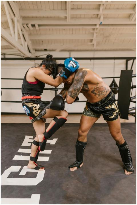 Two athletes engaged in a kickboxing training sess