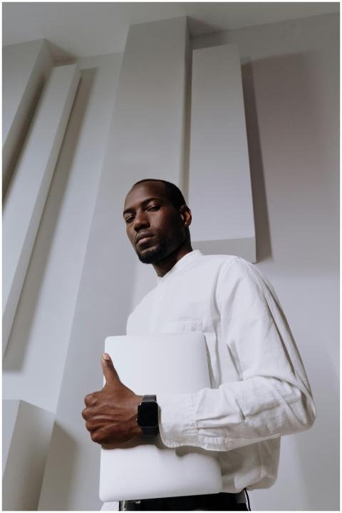 Professional African American man holding a laptop
