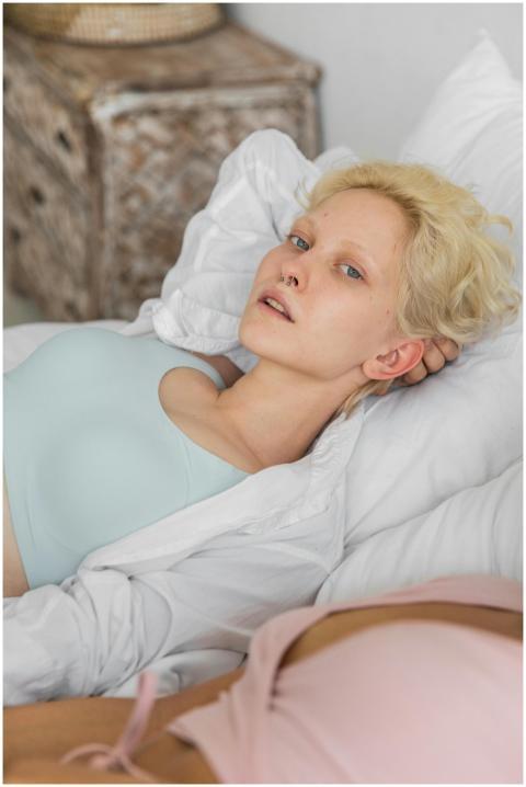 Serene adult woman relaxing in comfortable bedroom