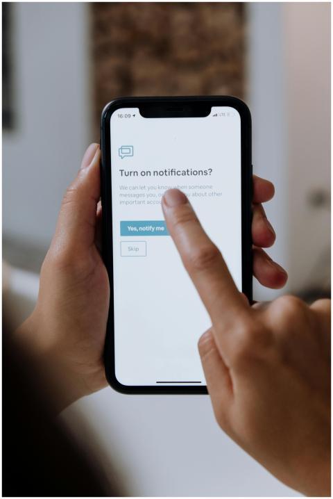 Close-up of hands using a smartphone for digital n
