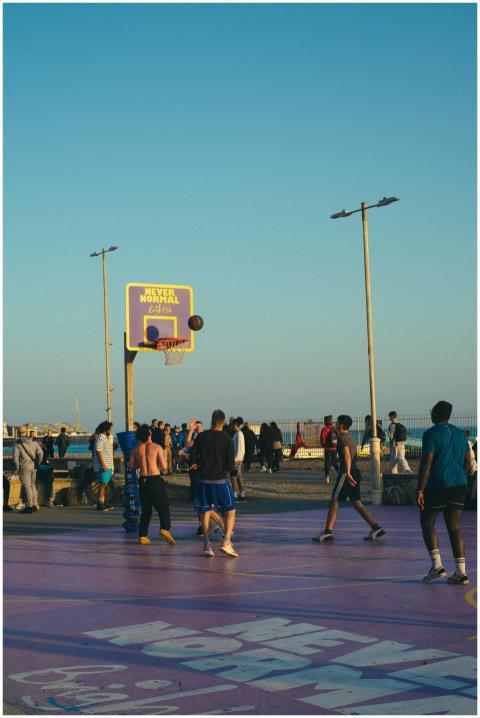 Dynamic street basketball game with players enjoyi