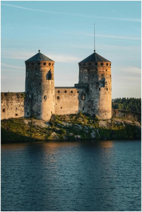 Olavinlinna Castle bathed in warm sunlight, locate