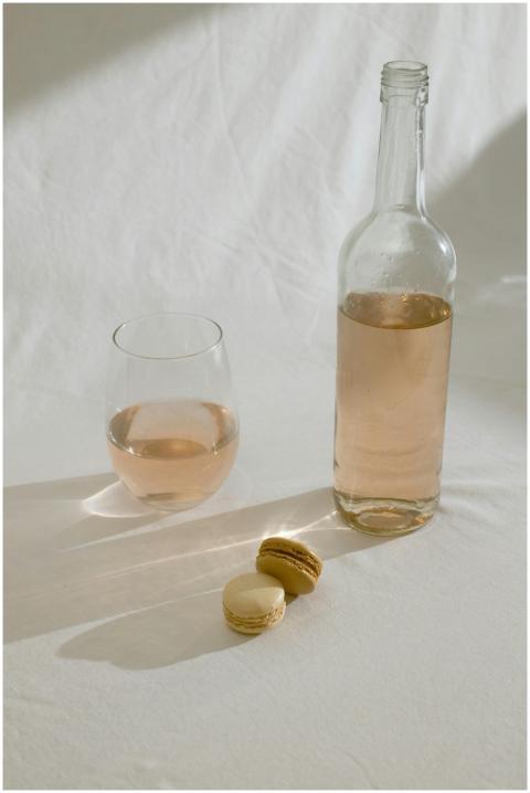 Stylish composition of rose wine and macarons on a