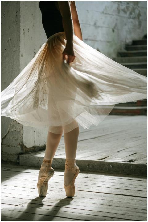 Ballet dancer in a tutu performing gracefully on p