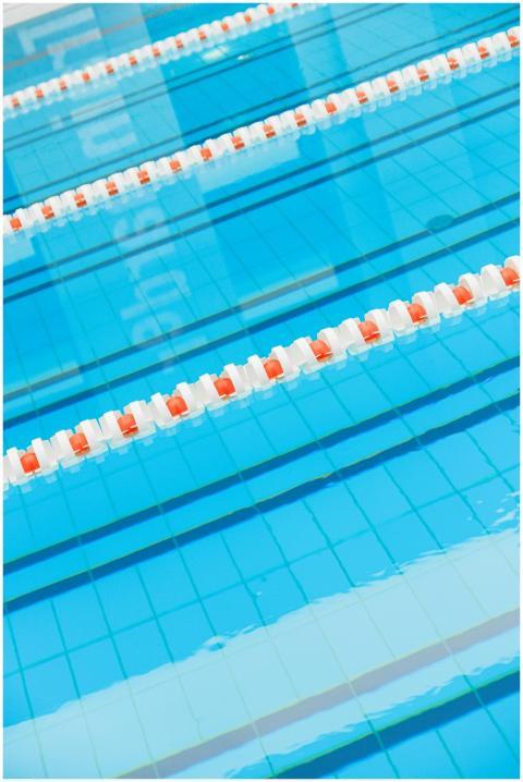 Indoor swimming pool with clear blue water and lan