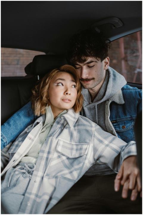 A young couple lovingly embraces while sitting in