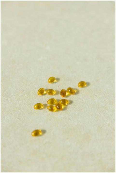 A collection of transparent golden capsules arrang