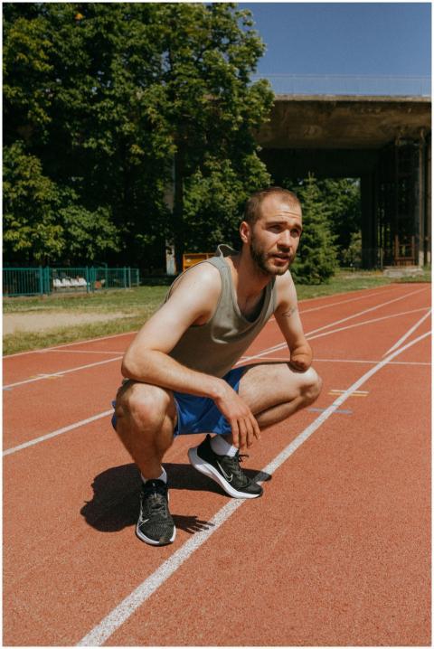 A determined male athlete with a prosthetic crouch