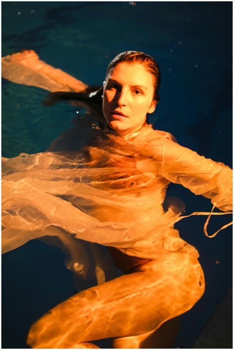 Elegant underwater portrait of a woman with flowin