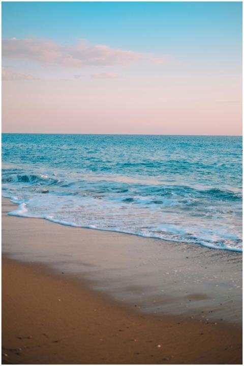 Beautiful beach scene with gentle waves and a past