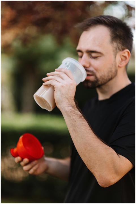 Close-up of man savoring a protein shake outdoors