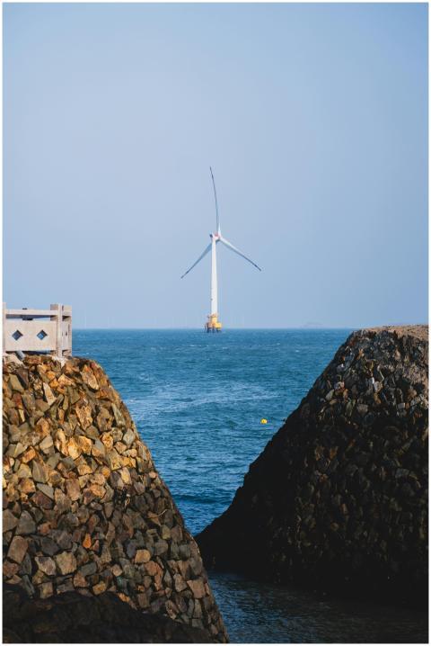 A lone offshore wind turbine stands majestically i