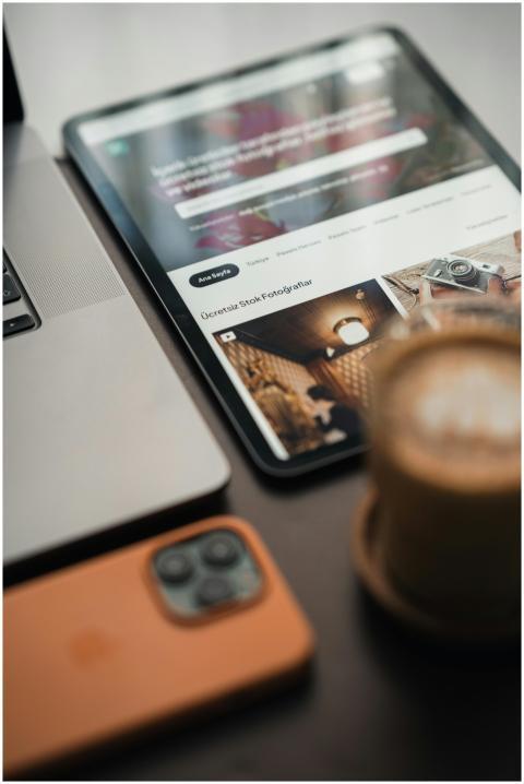 Close-up of a modern workspace with coffee, digita