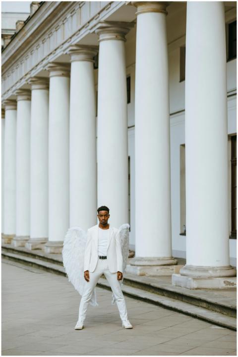 Elegant portrait of a man dressed as an angel, sta