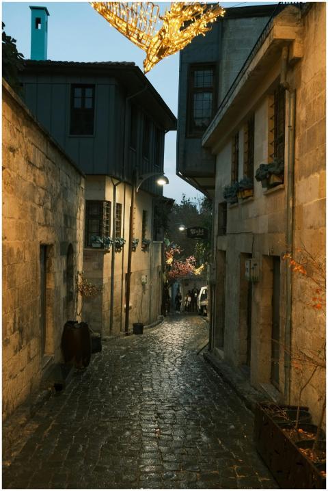 Peaceful cobblestone alley with glowing lights at