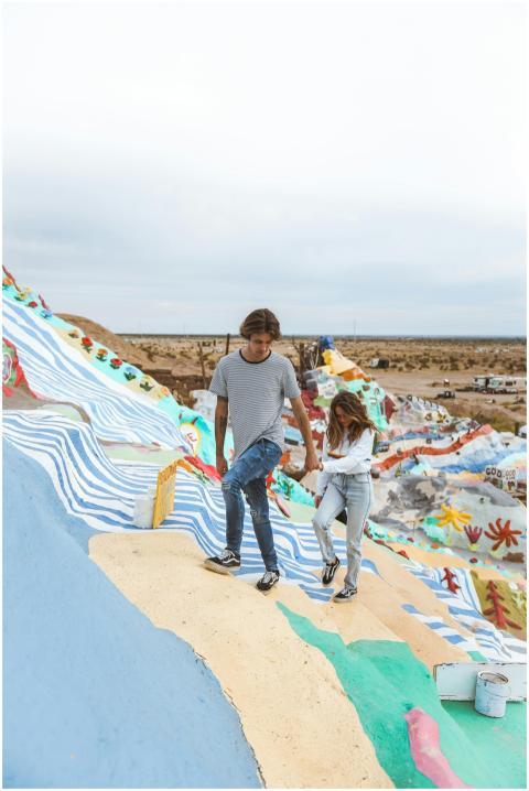 Couple exploring Salvation Mountain in California.