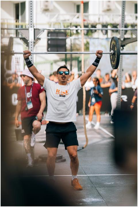 Athlete lifting barbell during an outdoor fitness