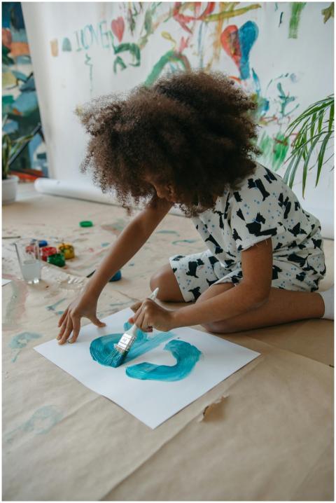 Child artist expressing creativity with bright col