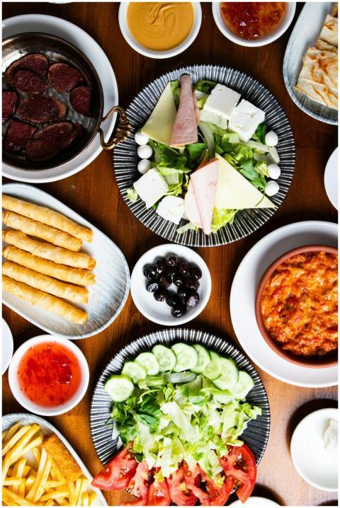 Top view of a vibrant buffet table with salads, di