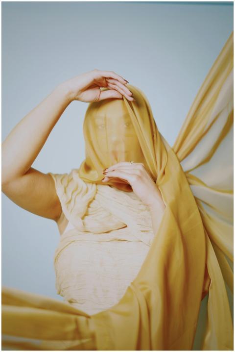 A captivating portrait featuring a person draped i