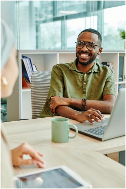 Cheerful man working at a desk in a modern office