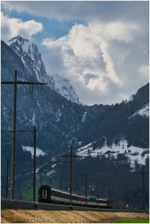 Train traveling through picturesque snowy mountain