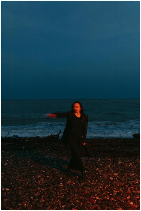 A mysterious blurred silhouette of a woman on a be