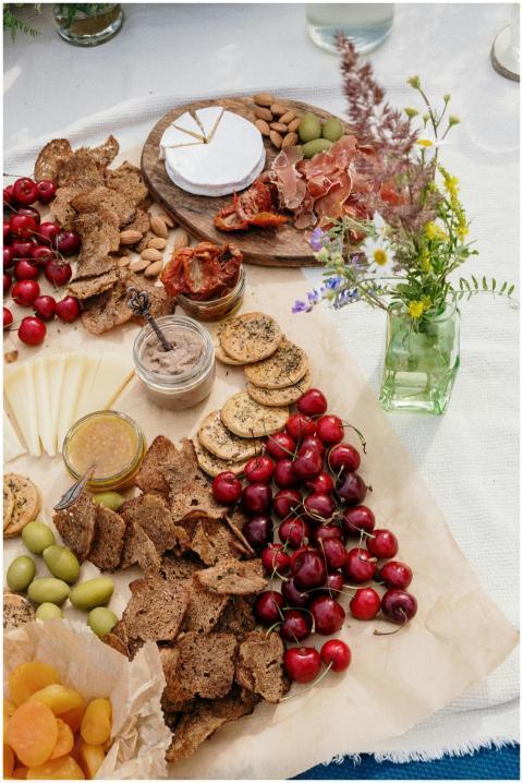 A delightful picnic spread featuring cherries, che