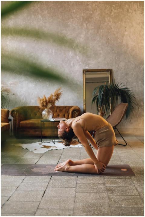Yoga practitioner in camel pose in a stylish indoo