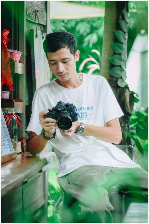 Casual portrait of a young man with a camera in a