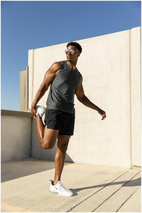 Athletic man stretching during a rooftop workout i