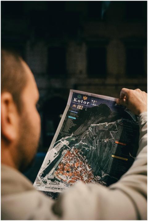 A person examines a detailed map of Kotor, Montene