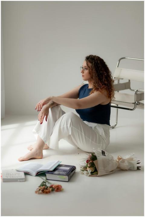 Young woman in a calm setting surrounded by books