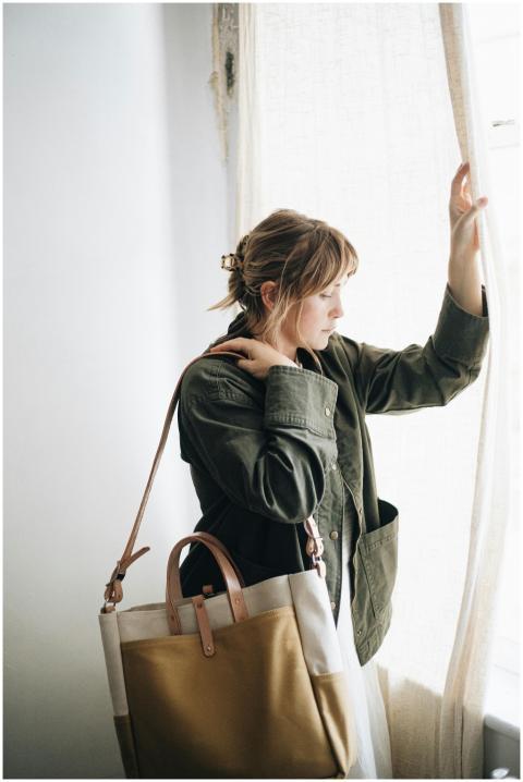 Stylish woman holding a handcrafted canvas and lea