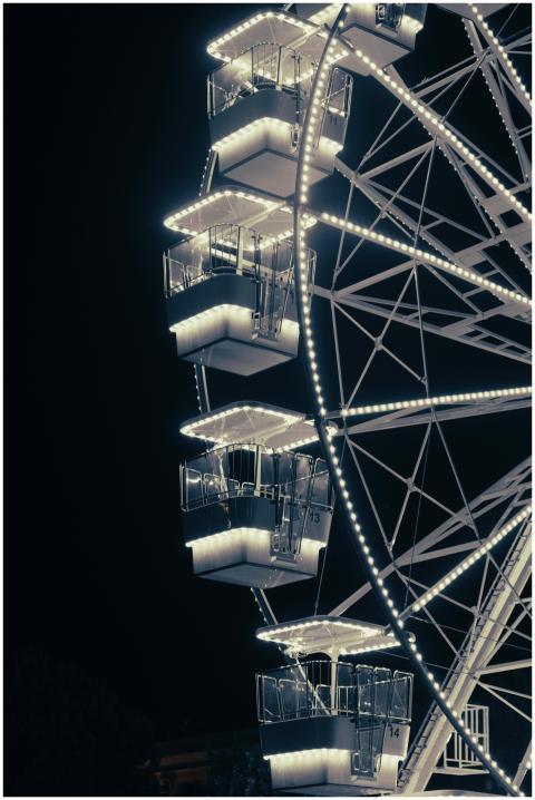 A brightly lit Ferris wheel against the night sky