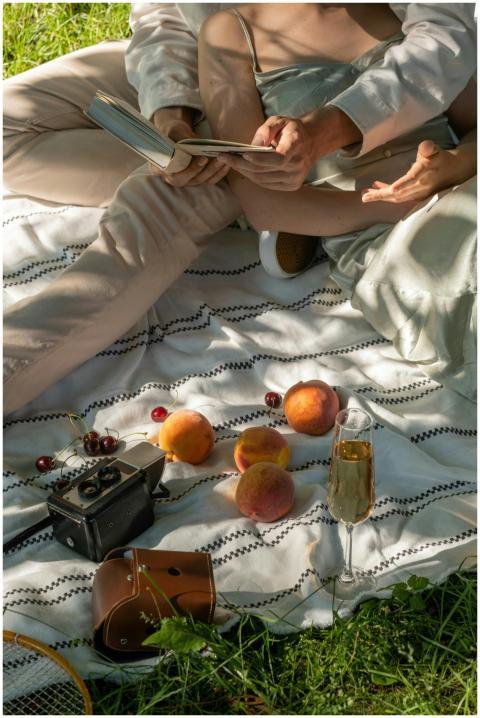 A couple enjoys a romantic picnic with peaches and